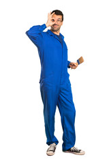 A full-length shot of a Painter man makes funny and crazy face emotion on isolated white background