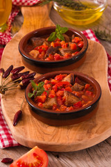 Marinated pork loin in tomato sauce.