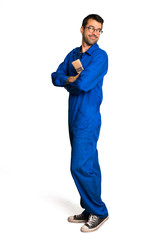 Fototapeta premium A full-length shot of a Painter man looking over the shoulder with a smile on isolated white background