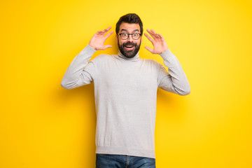 Man with beard and turtleneck with surprise and shocked facial expression