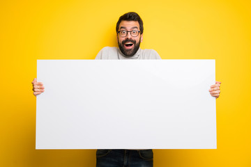 Man with beard and turtleneck holding a placard for insert a concept