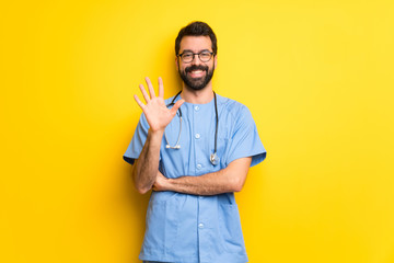 Surgeon doctor man counting five with fingers