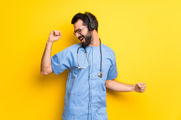 Surgeon doctor man listening to music with headphones and dancing