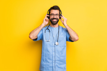 Surgeon doctor man listening to music with headphones