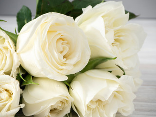 White roses on a white wooden table