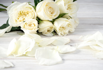 White roses on a white wooden table