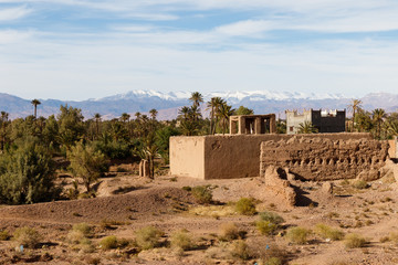 Fortified city along the former caravan route between the Sahara and Marrakech in Morocco with snow covered Atlas mountain range in background