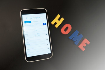 Fototapeta premium Search for a new home on a mobile device, conceptual photo