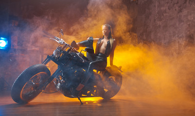 Young  woman sitting on motorcycle