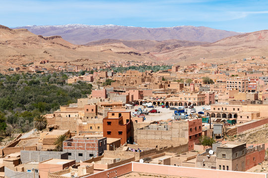 Fortified city of Tinghir along the former caravan route between the Sahara and Marrakech in Morocco with snow covered Atlas mountain range in background