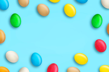 Multicolored Easter eggs on a blue background. Copy space. Easter.