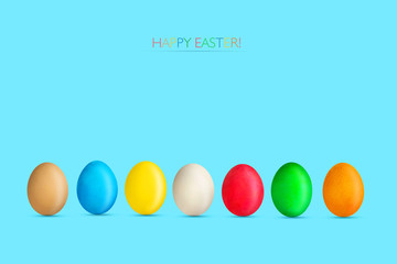 Multicolored Easter eggs on a blue background. Copy space. Easter.