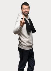 Sport man showing and lifting a finger over isolated grey background