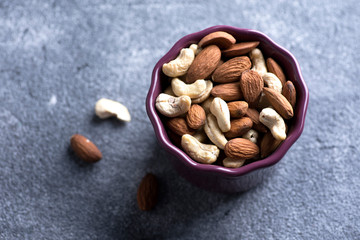 Almond and cashew nuts in a bowl. Top close-up view