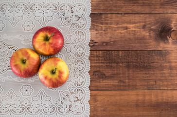 Apples on a wooden background and lace napkin. Proper diet. Healthy diet. Vegetarianism. Proper Breakfast. The right snack.