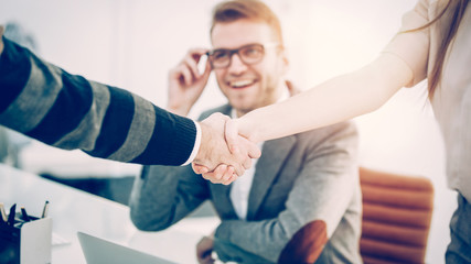 Fototapeta premium handshake of business partners on the background of the professional employee