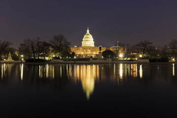 Stunning night-time reflection of the United States Capitol Building on the surface of the Capitol Reflecting Pool, Union Square, Washington DC
