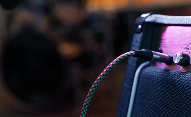 Part of guitar amp with plug in cable. Music concert or recording concept. Copy space