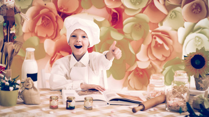 cute little baby is preparing tasty meals in the kitchen