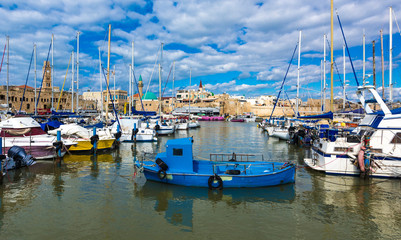 Fototapeta premium View on marina with yachts and ancient walls of harbor in old city Acre, Israel, Middle East