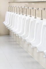 Row of outdoor urinals men of public toilet