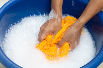 Fototapeta premium Hands washing color clothes.
