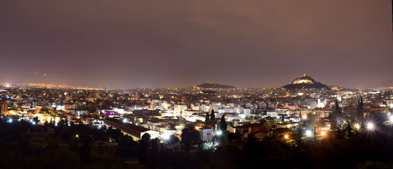 Image shows a night view of the capital of Greece-Athens shot from the  Areopagus hill located next to Acropolis.