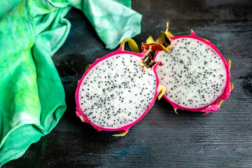 halved pink and green dragon fruit with white flesh