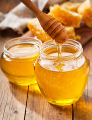 jar of honey with honeycombs