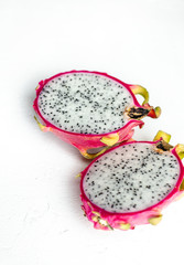 halved pink and green dragon fruit with white flesh