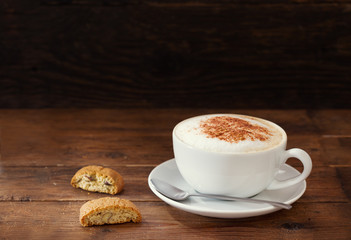 cup of cappuccino coffee with cookies