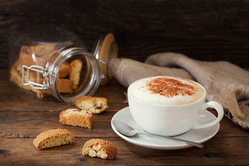 cup of cappuccino coffee with cookies
