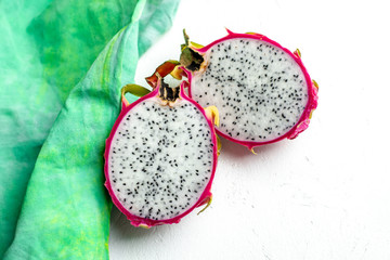 halved pink and green dragon fruit with white flesh