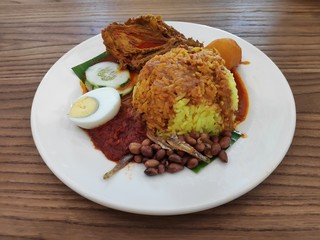 Nasi Lemak serve with chicken curry,egg,cucumber sliced,anchovies,ground nut and sambal.