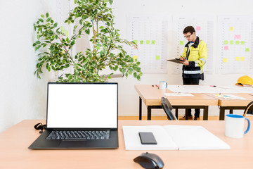 Worker Writing In Conference Room With Laptop On Foreground