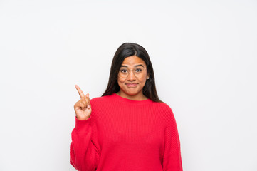 Young Colombian girl with glasses pointing with the index finger a great idea