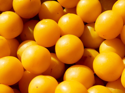 Ripe yellow summer fruits gathered into a pile close up