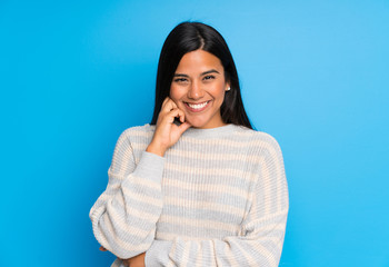 Young Colombian girl with sweater laughing