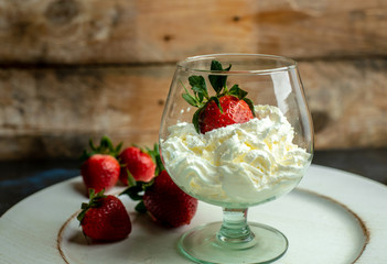 whipped cream with strawberries in a romantic glass