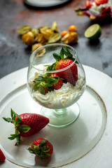 whipped cream with strawberries in a romantic glass