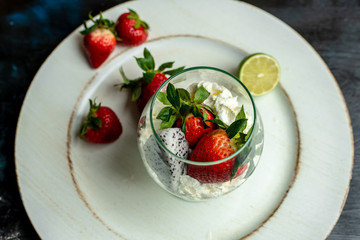 whipped cream with strawberries in a romantic glass