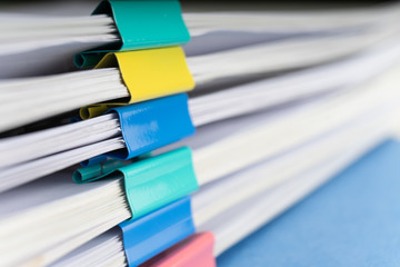 Mock up, stack of papers documents in archives files with paper clips on desk at offices, business concept. Copy space.
