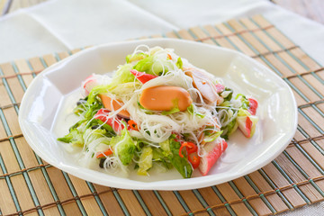 Spicy salad rice vermicelli with sausage, crab stick, green oak. healthy food concept 