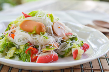 Spicy salad rice vermicelli with sausage, crab stick, green oak. healthy food concept 