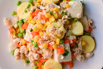 stir-fries egg tofu with minced chicken, pea, and carrot. Healthy food concept