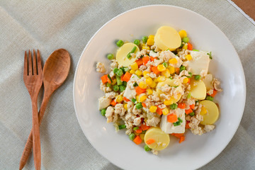 stir-fries egg tofu with minced chicken, pea, and carrot. Healthy food concept