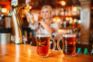 Two glasses of fresh beer on counter, octoberfest