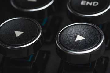 An extreme close-up or macro shot of a round directional arrow key on a vintage-inspired...