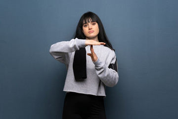 Young sport woman making time out gesture