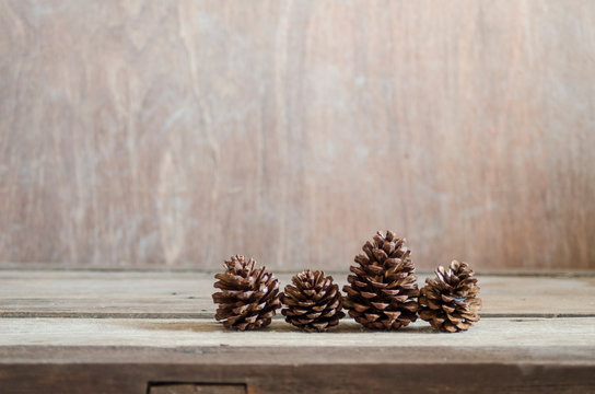 pine cones on wood background 